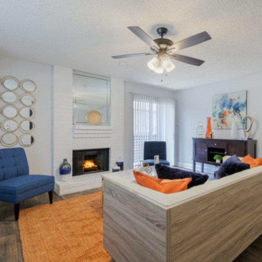 living room with orange rug and blue accent chair